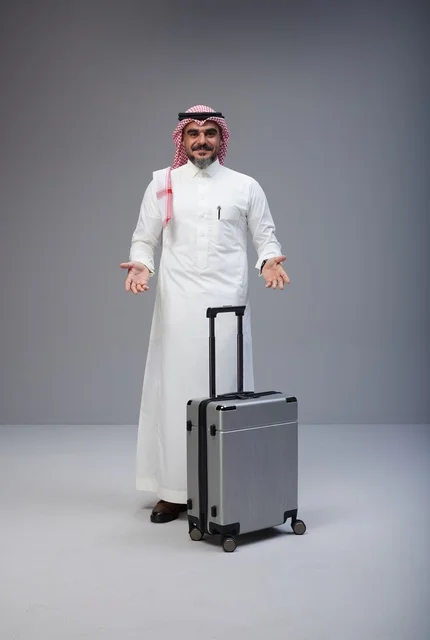 رجل سعودي بالزي التقليدي مع حقيبة سفر