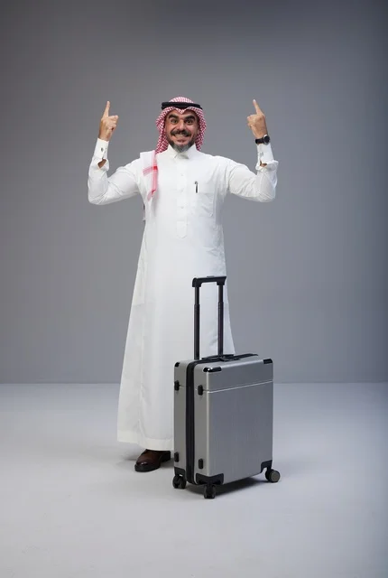 Saudi Man with Travel Suitcase Pointing Upwards