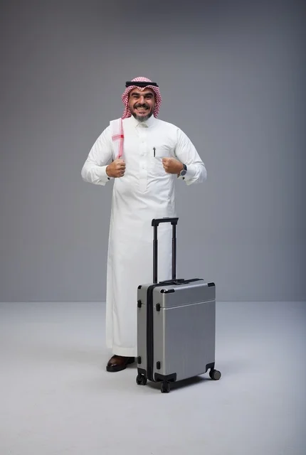 رجل سعودي بالزي التقليدي مع حقيبة سفر