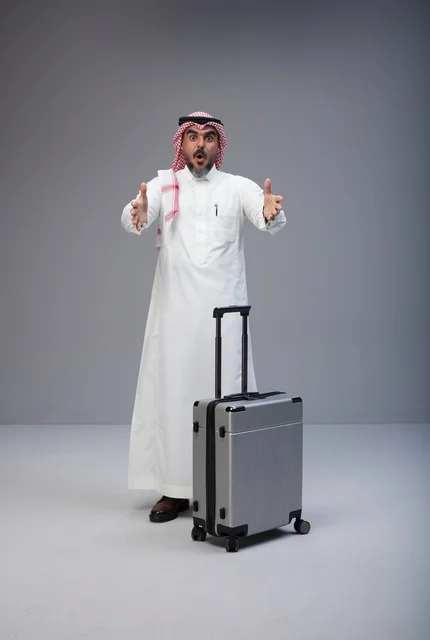 Shocked Saudi Man in Traditional Dress with Suitcase