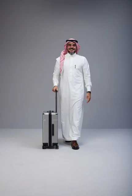 Saudi Man in Traditional Dress Walking with Suitcase
