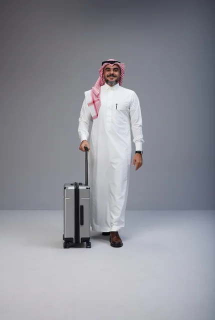 Saudi Man in Traditional Thobe Walking with Suitcase Saudi Man in Traditional Thobe Walking with Suitcase