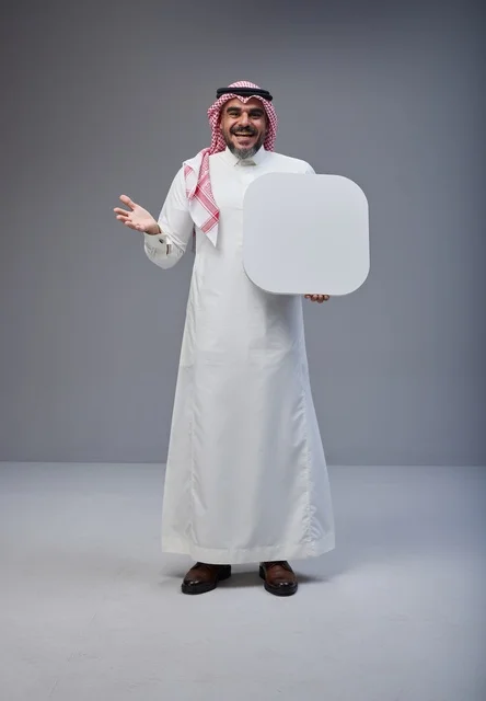 Smiling Saudi Man Holding Blank White Board in Studio