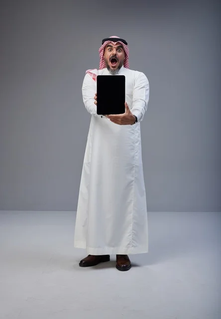 Saudi Man with Tablet and Shocked Expression in Studio