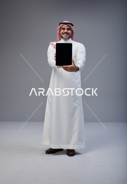 Saudi Man Holding Tablet Blank Screen Studio Shot