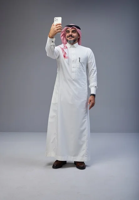 Saudi Man in Traditional Thobe Taking a Selfie