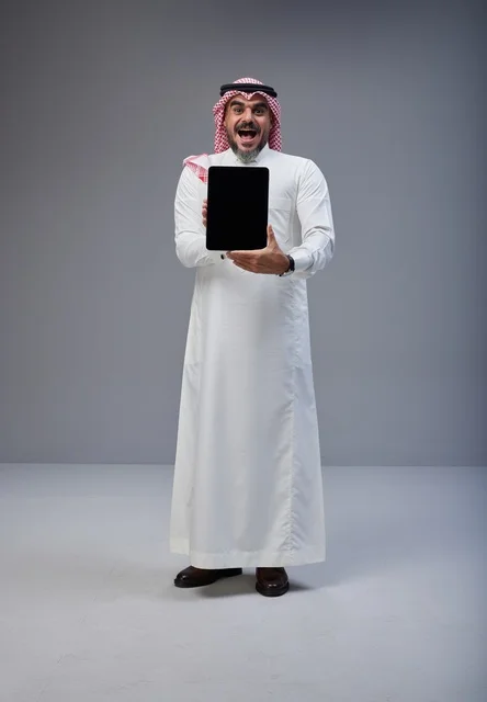 Saudi Man Holding Blank Tablet Screen with Excited Face