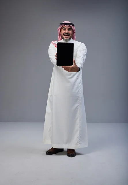 Saudi Man in Traditional Thobe Holding Blank Tablet