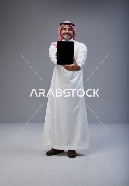 Saudi Man Holding Blank Tablet Screen in Studio