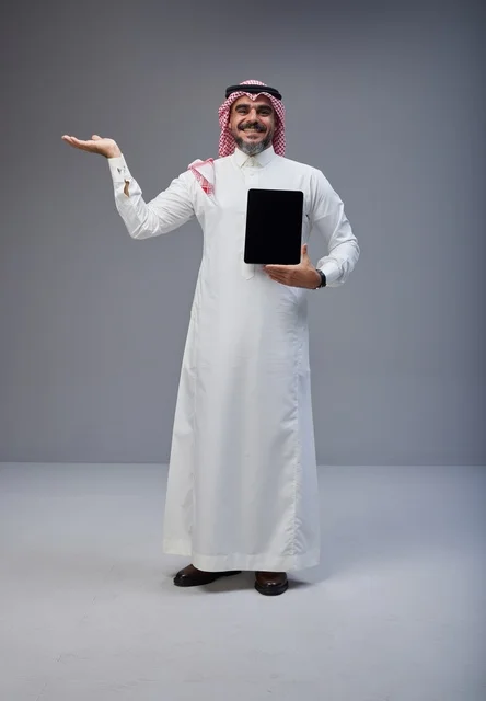 Saudi Man in Traditional Dress Holding Blank Tablet
