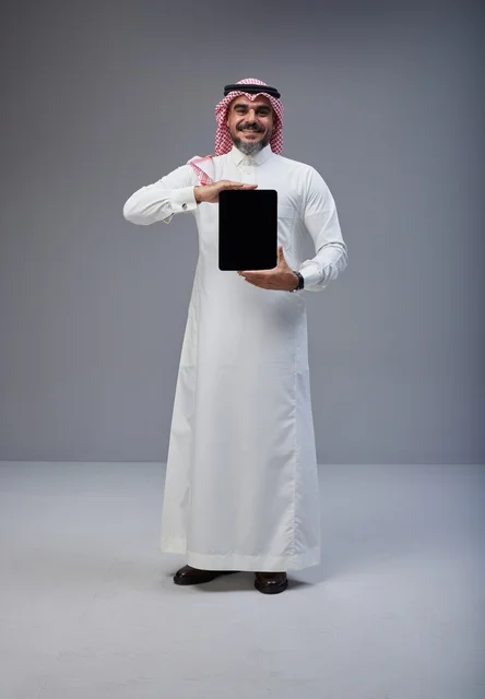 Saudi Man Holding Tablet with Blank Screen in Studio