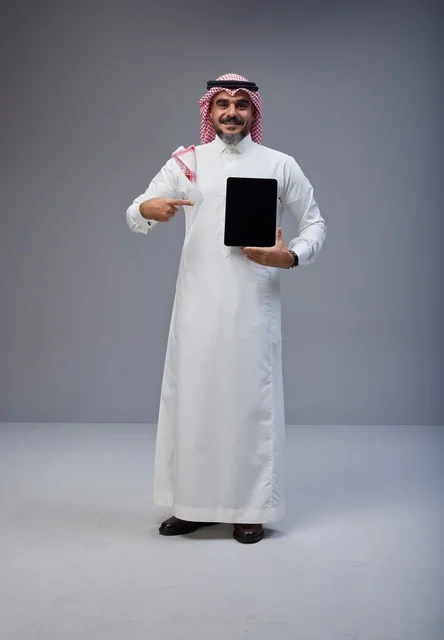 Saudi Man in Traditional Dress Holding Tablet Screen