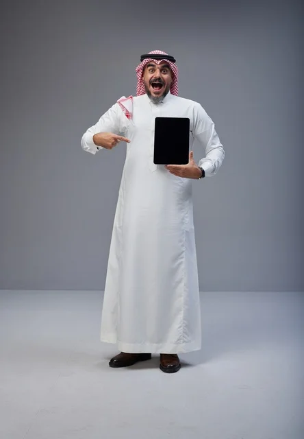 Saudi Man Pointing at Blank Tablet Screen in Studio