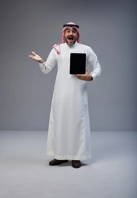 Saudi Man in Traditional Dress with Blank Tablet Screen
