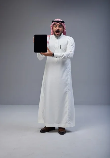 Saudi Man Holding Tablet with Blank Screen