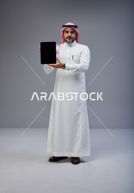 Saudi Man Holding Tablet Blank Screen in Studio