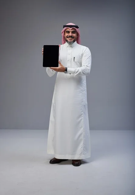 Saudi Man Holding Tablet with Blank Screen in Studio