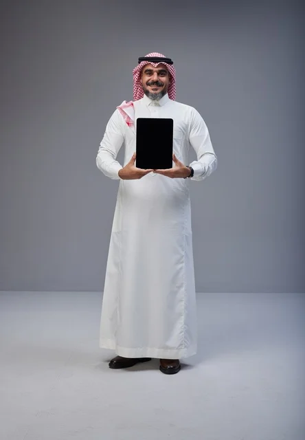 Saudi Man in Traditional Dress with Blank Tablet Screen