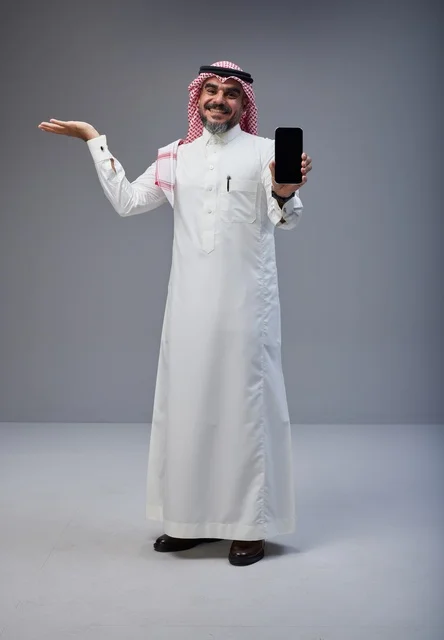 Saudi Man in Traditional Thobe Holding Smartphone Screen