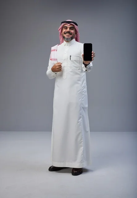 Saudi Man in Traditional Thobe Holding Smartphone Screen