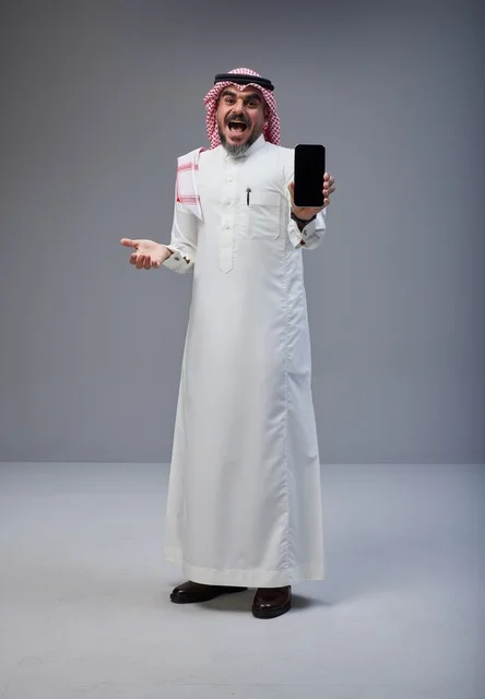 Saudi Man in Traditional Dress Showing Smartphone Screen