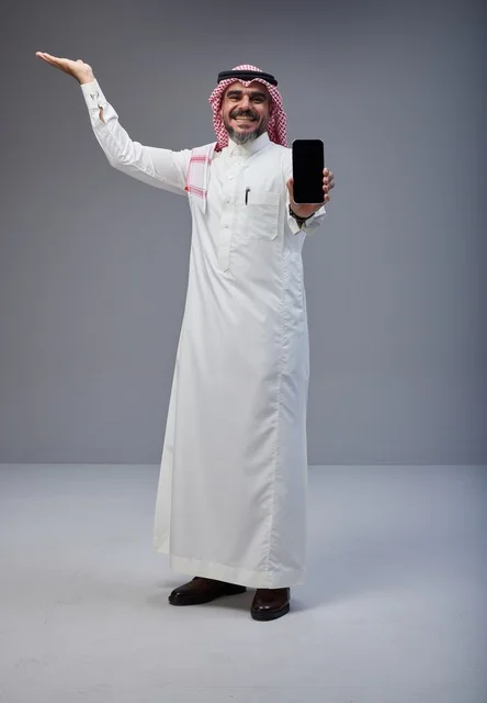 Saudi Man in Traditional Dress Holding Smartphone Screen