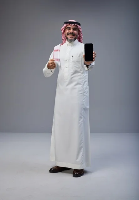 Saudi Man in Traditional Dress Holding Smartphone Screen