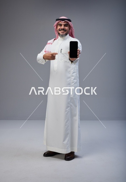Saudi Man Pointing at Blank Smartphone Screen