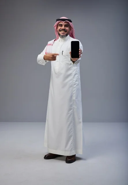 Saudi Man in Traditional Dress Pointing at Smartphone