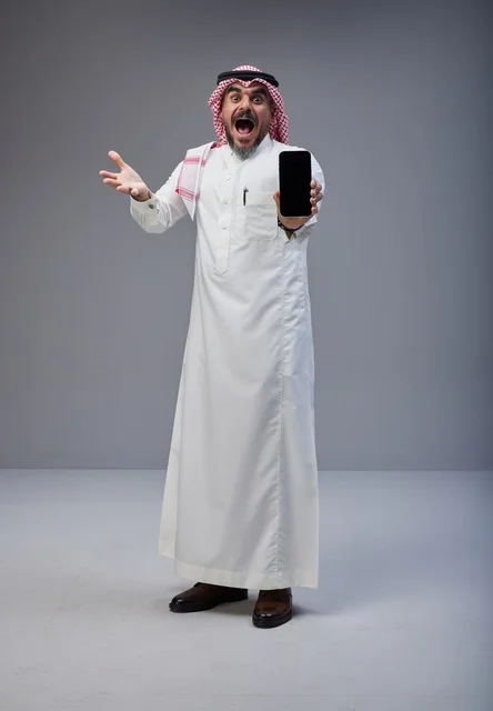 Surprised Saudi Man Holding Smartphone Blank Screen