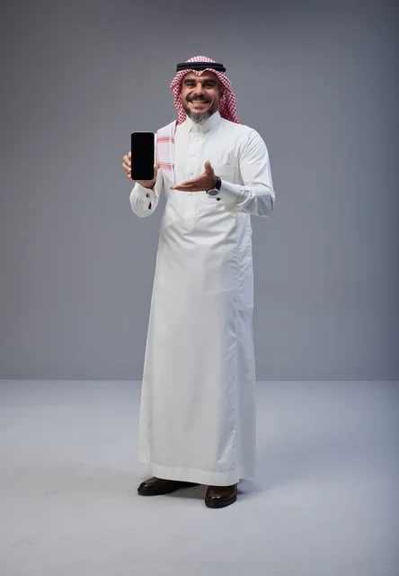Saudi Man in Traditional Dress Holding Smartphone Screen