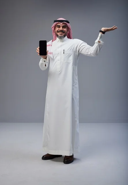 Saudi Man in Traditional Dress Holding Smartphone