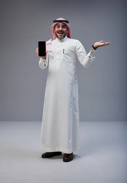 Saudi Man in Traditional Thobe Holding Blank Smartphone