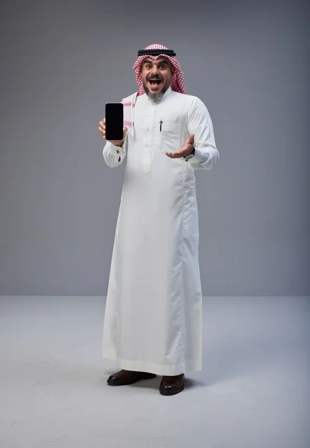 Saudi Man in Traditional Thobe Holding Smartphone
