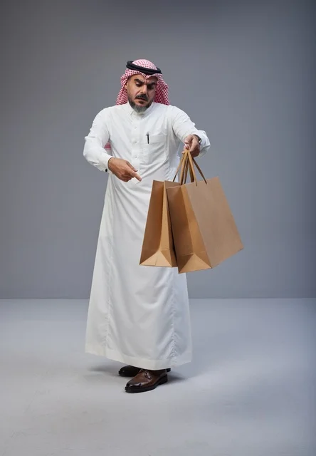 Saudi Man Holding Shopping Bags in Studio