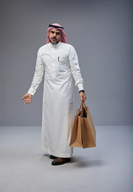 Saudi Man Holding Shopping Bags in Studio