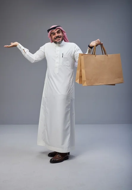 Saudi Man in Traditional Dress with Shopping Bags