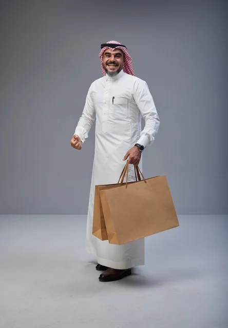 Saudi Man Holding Shopping Bags in Studio