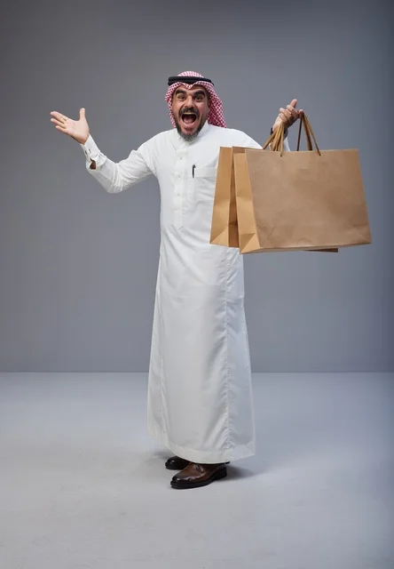 Excited Saudi Man with Shopping Bags in Studio
