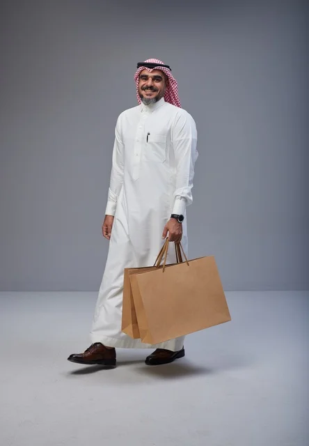 Saudi Man in Traditional Dress with Shopping Bags Studio