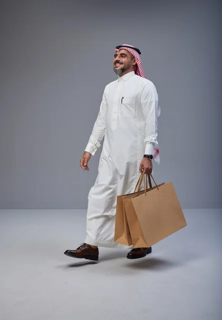 Saudi Man Carrying Shopping Bags in Studio