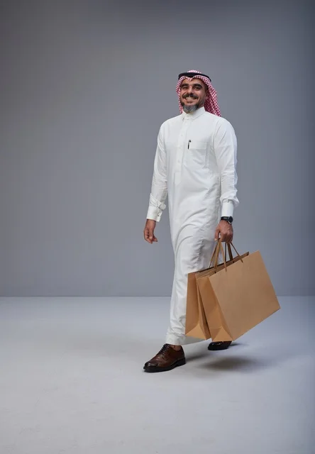 Saudi Man in Traditional Dress with Shopping Bags