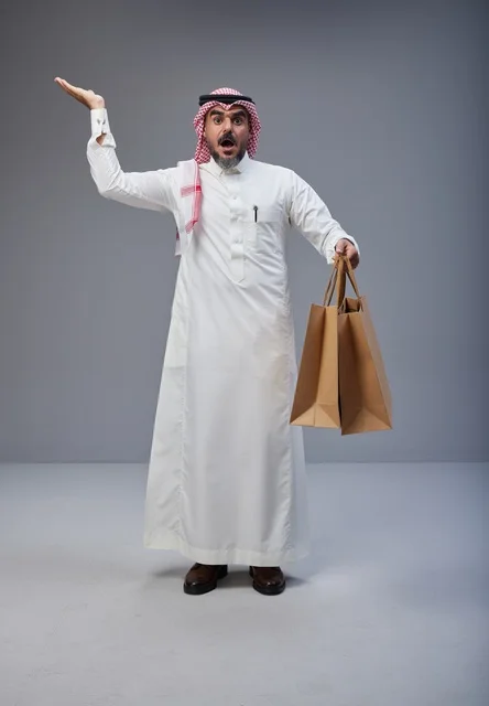Shocked Saudi Man with Shopping Bags in Studio
