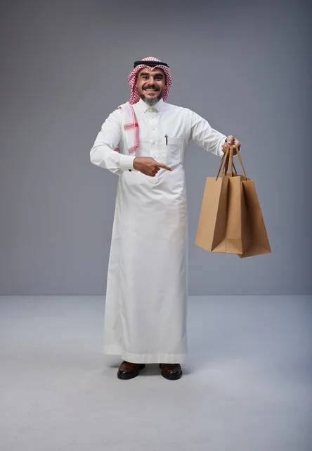 Saudi Man Holding Shopping Bags in Studio