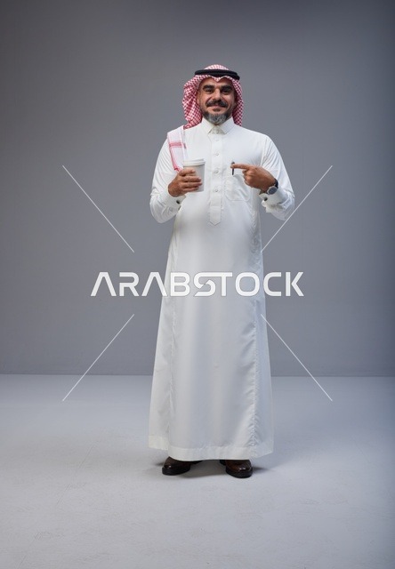 Saudi Man in Traditional Thobe Holding Coffee Cup