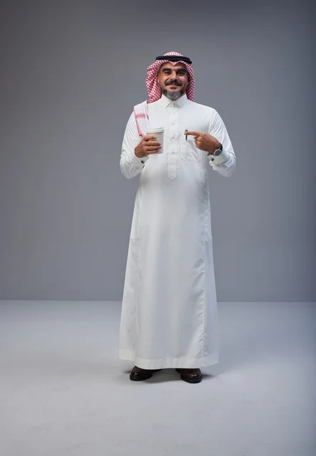 Saudi Man in Traditional Thobe Holding Coffee Cup
