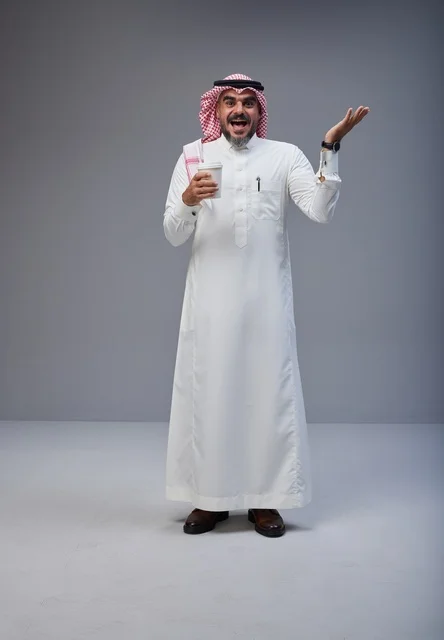 Excited Saudi Man in Traditional Thobe Holding Coffee Excited Saudi Man in Traditional Thobe Holding Coffee