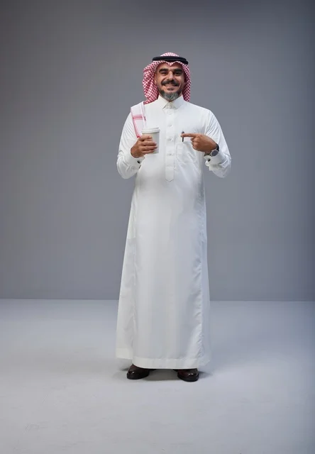 Saudi Man in Traditional Thobe Holding Coffee Cup