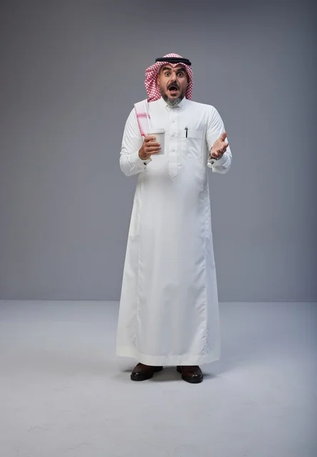 Shocked Saudi Man Holding Coffee Cup in Studio