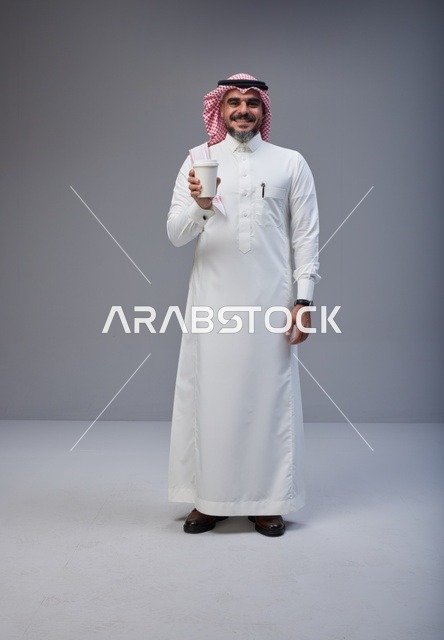 Saudi Man in Traditional Thobe Holding Coffee Cup